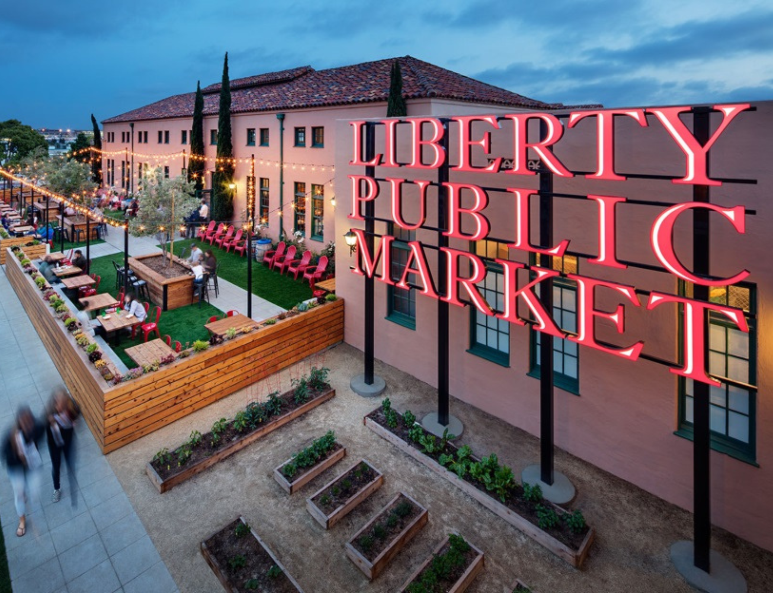 The Liberty Public Market Sign in front of a building