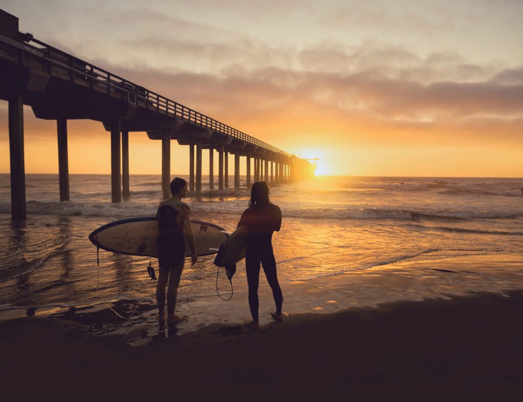 Two surfers watching the sunset