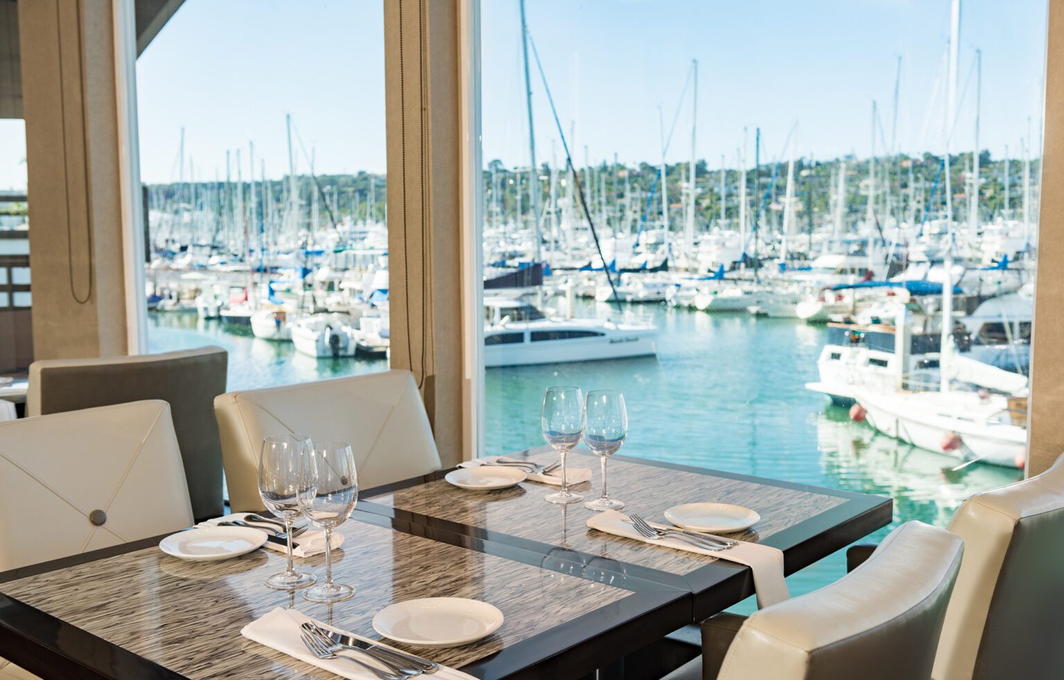 a dining table with a view of the marina