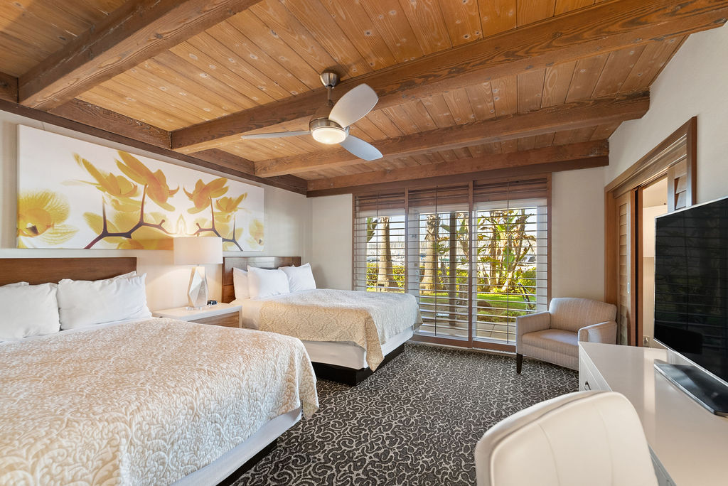 Guest room two queen beds and TV