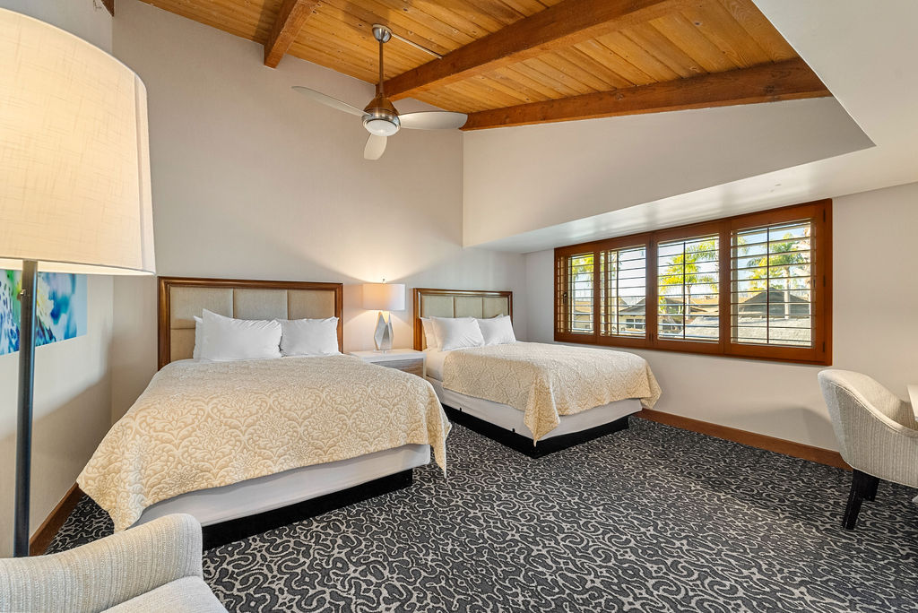 Two queen beds with large window