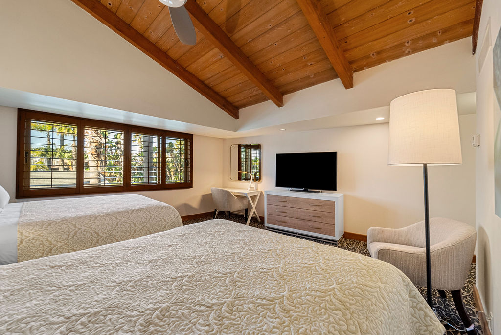 Two queen beds with tv and desk