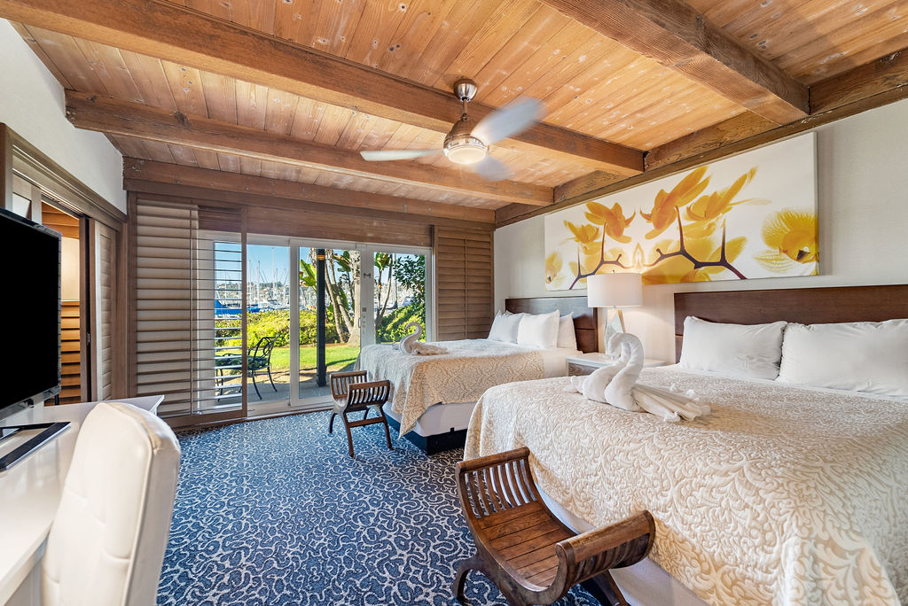 Two queen beds with view of patio