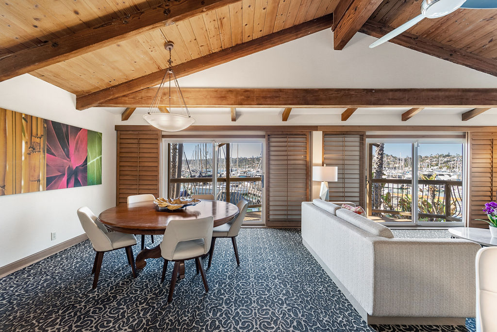 Dining area with view of couch and outdoor balcony