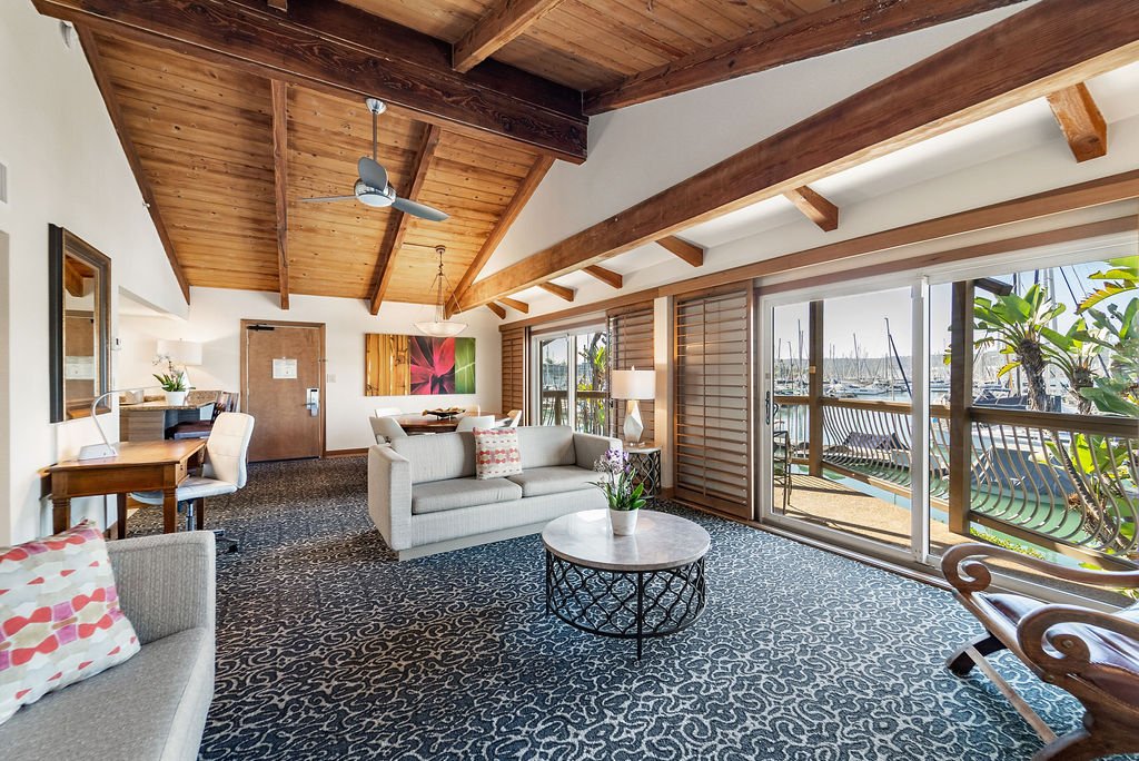 living area with view of balcony overlooking marina