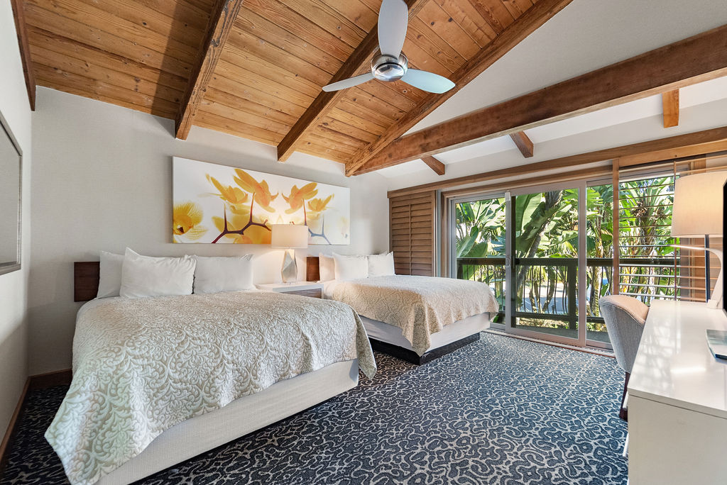Two Queen beds with view of balcony