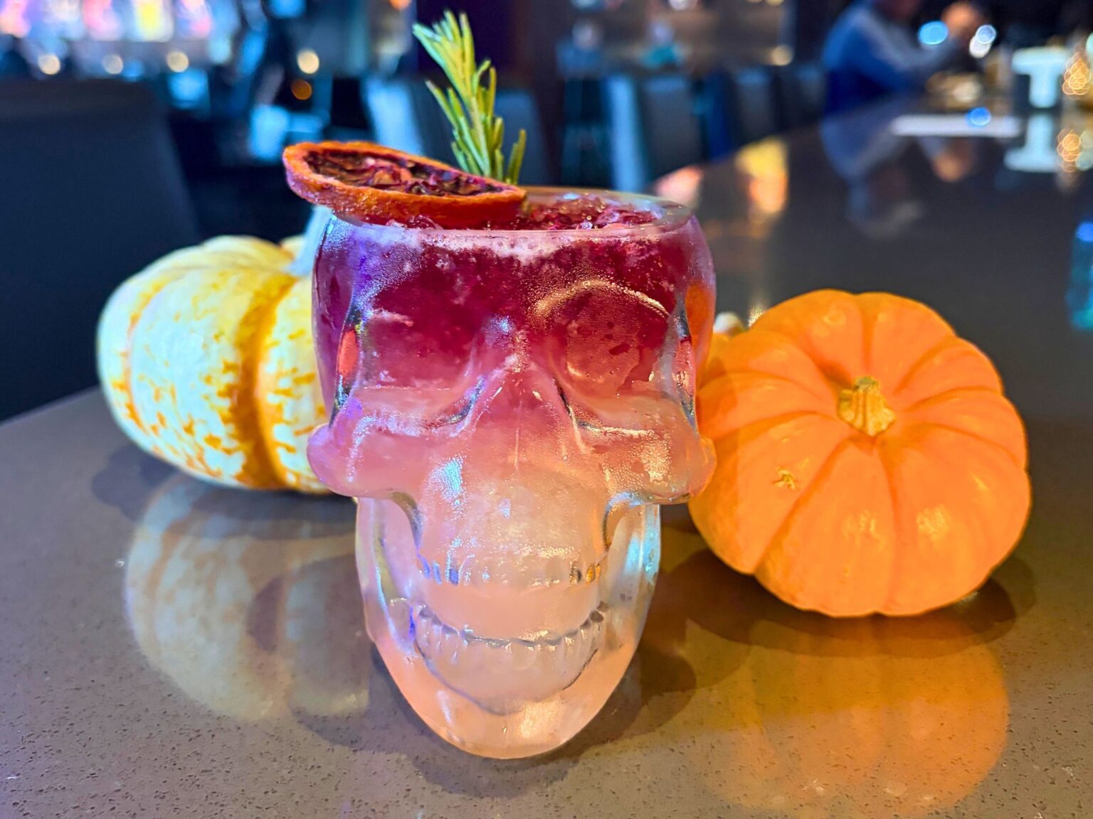 Halloween Skull Drink on counter next to pumpkins