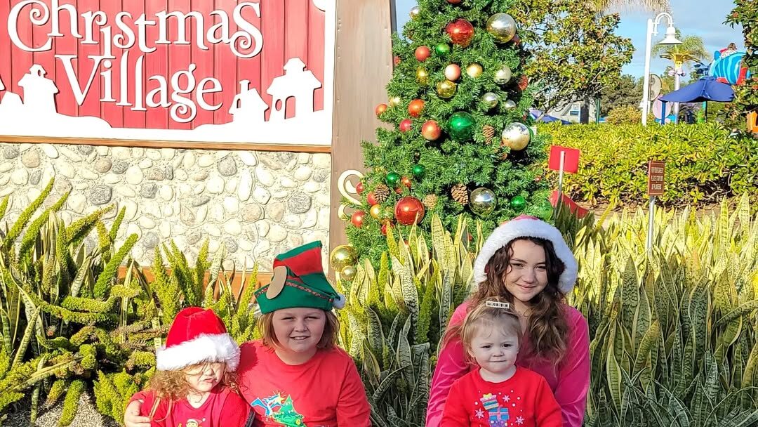 kids sitting in front of sign
