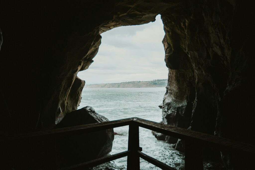 a view of the sea through a cave opening