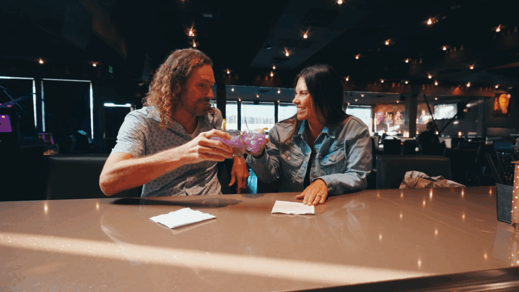 Two guests enjoying drinks at Backstage LIVE bar