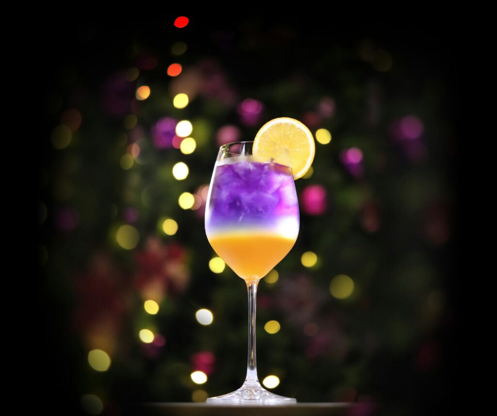 a lit up cocktail with christmas decor